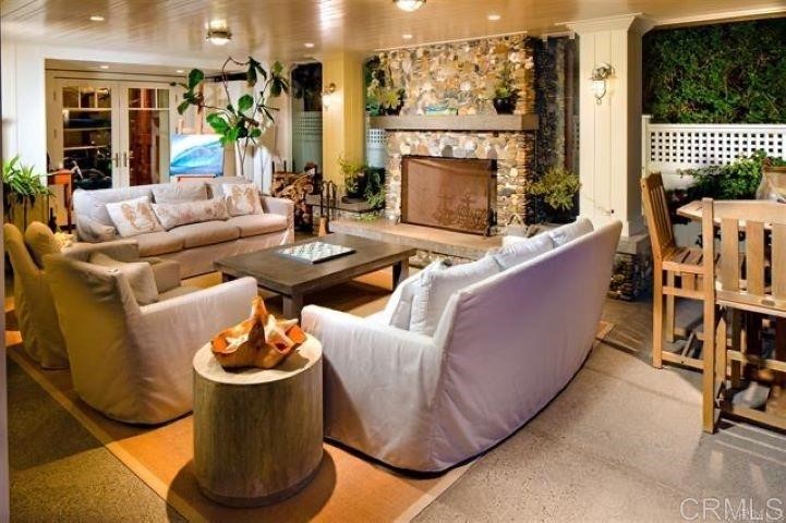 111 10th Street Del Mar, CA 92014 - Photo 6 of 23 a living room with furniture a fireplace and a floor to ceiling window