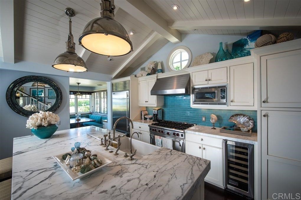 111 10th Street Del Mar, CA 92014 - Photo 10 of 23 a kitchen with stainless steel appliances a stove a sink and a refrigerator