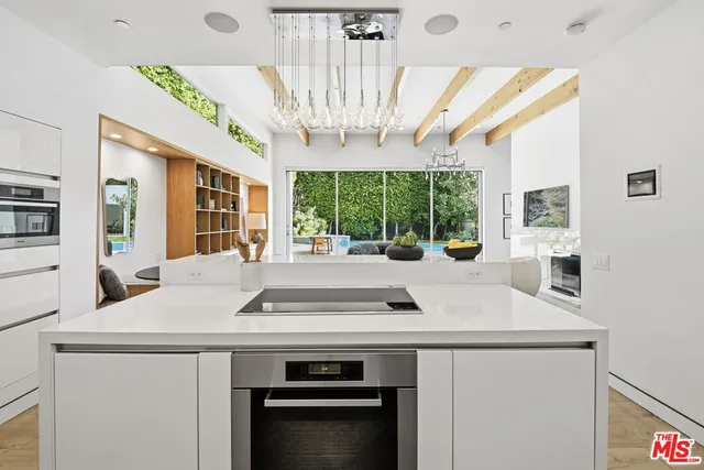 a kitchen with a stove and a chandelier