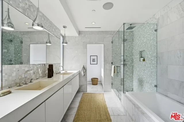a spacious bathroom with a bathtub shower sink and mirror