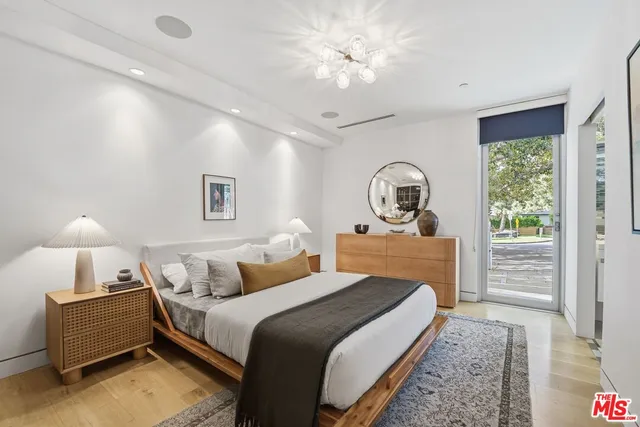 a bedroom with a bed and a chandelier