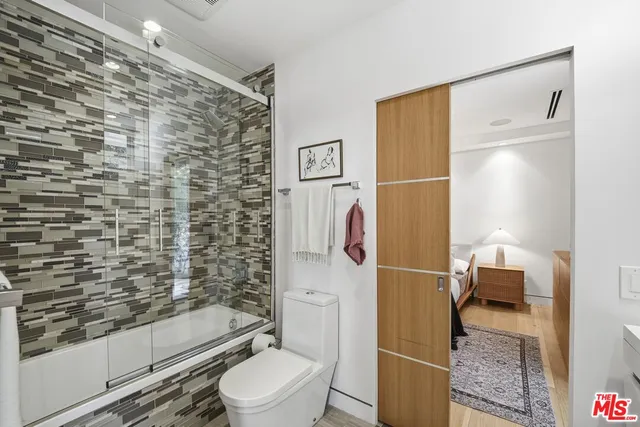 a bathroom with a toilet and a shower