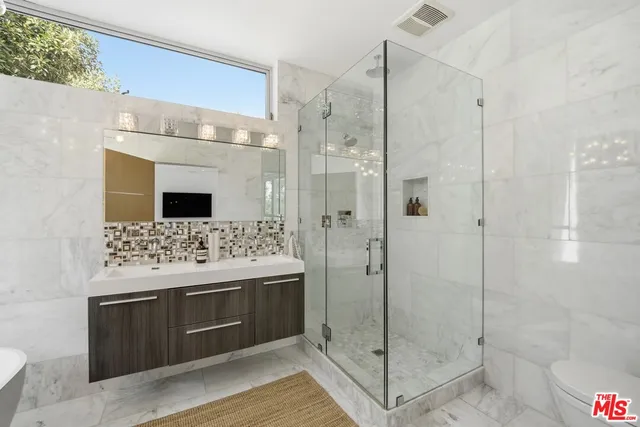 a bathroom with a shower sink and mirror