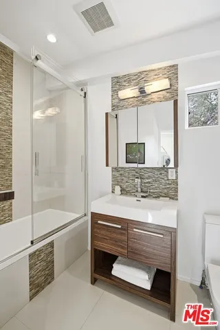 a bathroom with a tub and a shower