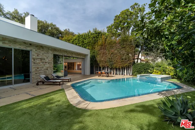 swimming pool view with a seating space