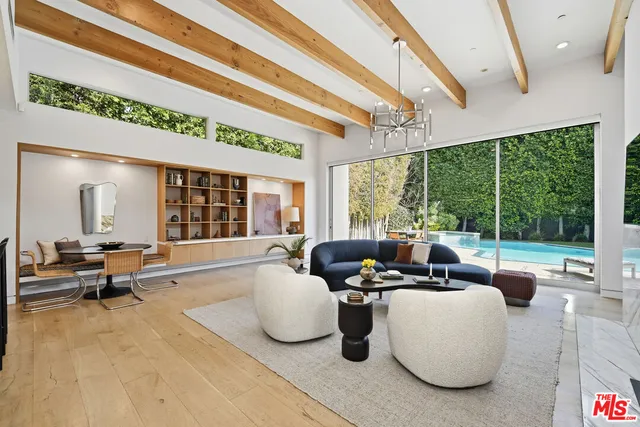 a living room with furniture and a floor to ceiling window