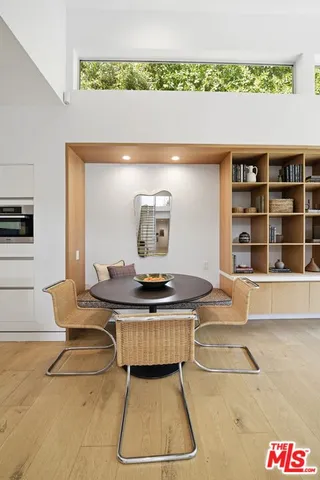 a living room with a table and chairs in it