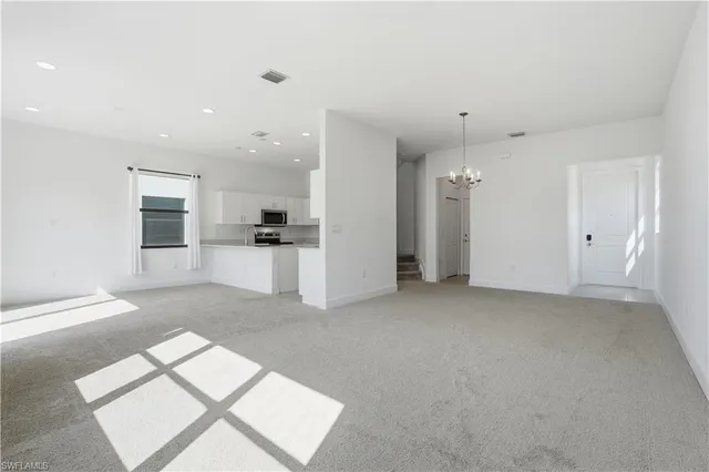 a view of a big room with closet and windows