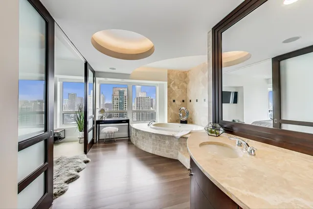 a bathroom with a granite countertop sink a toilet and mirror