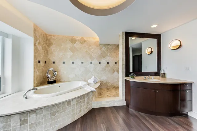 a kitchen with a sink a refrigerator and cabinets