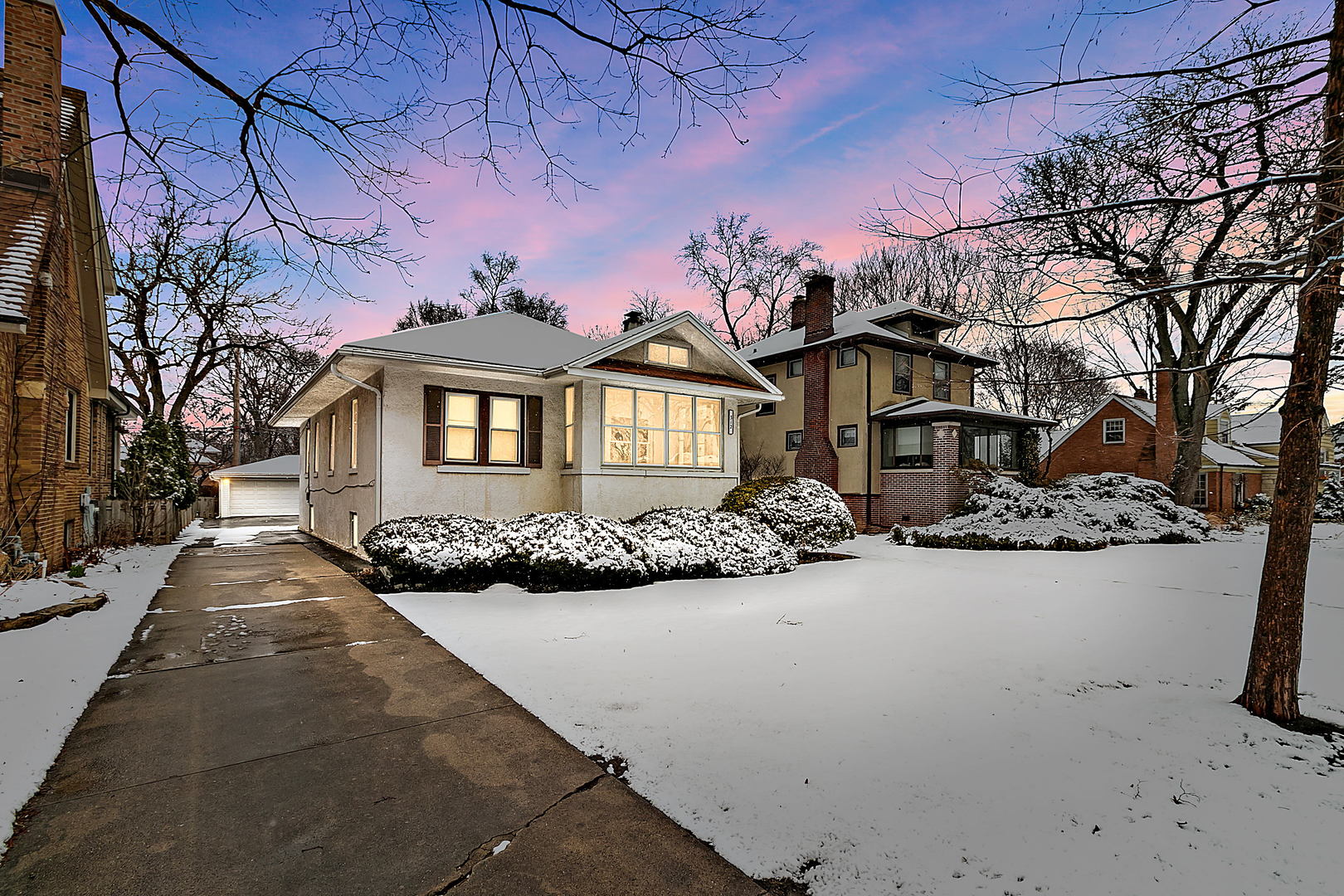 a front view of a house with yard covered in snow