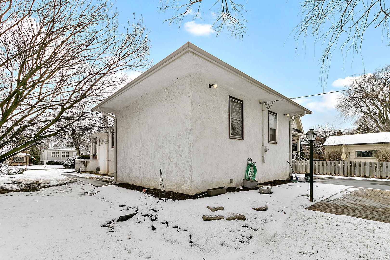 312 Gage Road Riverside, IL 60546 - Photo 16 of 26 a view of white house with a yard covered in snow