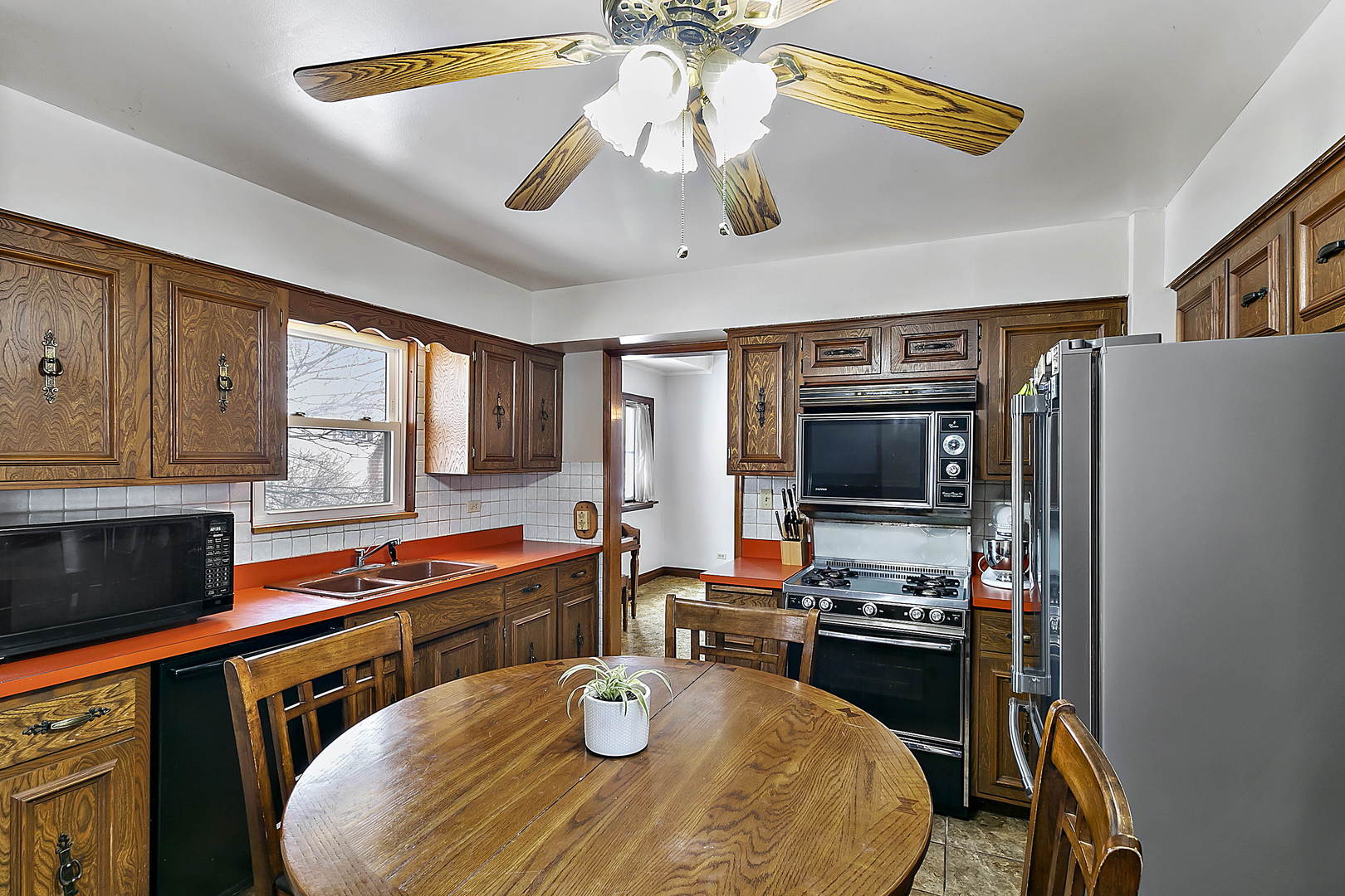 312 Gage Road Riverside, IL 60546 - Photo 5 of 26 a kitchen with a table chairs stove and refrigerator