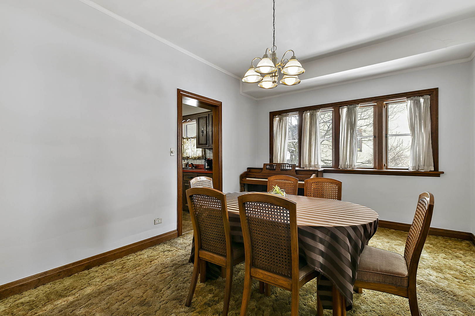 312 Gage Road Riverside, IL 60546 - Photo 6 of 26 a view of a dining room with furniture a chandelier and wooden floor