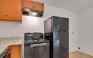 a kitchen with a stove and a refrigerator