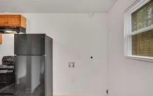 a kitchen with stainless steel appliances a refrigerator and a window