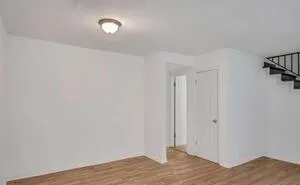 a view of a room with wooden floor