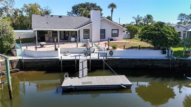 a view of house with yard swimming pool and outdoor seating