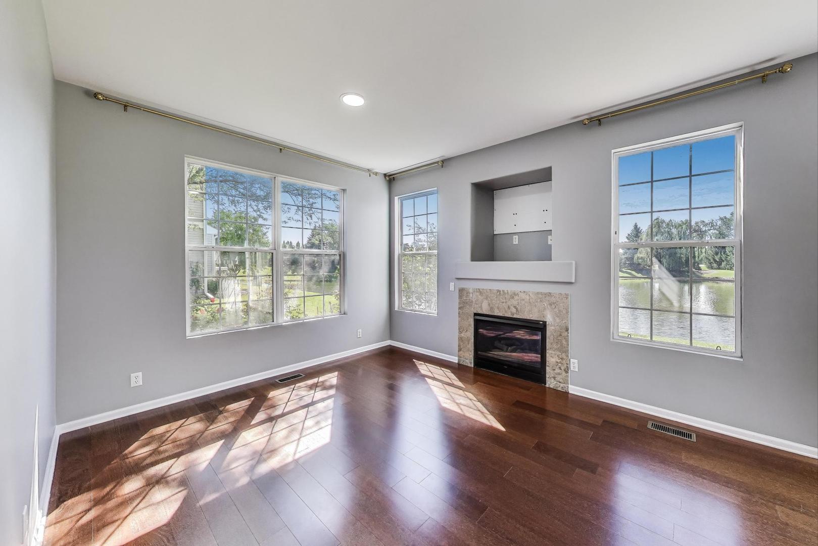 383 Cascade Lane Oswego, IL 60543 - Photo 11 of 35 a view of an empty room with window and fire place