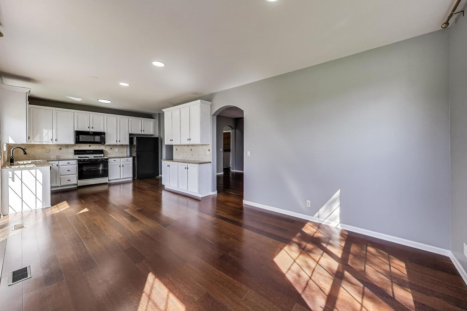 383 Cascade Lane Oswego, IL 60543 - Photo 13 of 35 a kitchen with stainless steel appliances granite countertop a refrigerator and a stove top oven