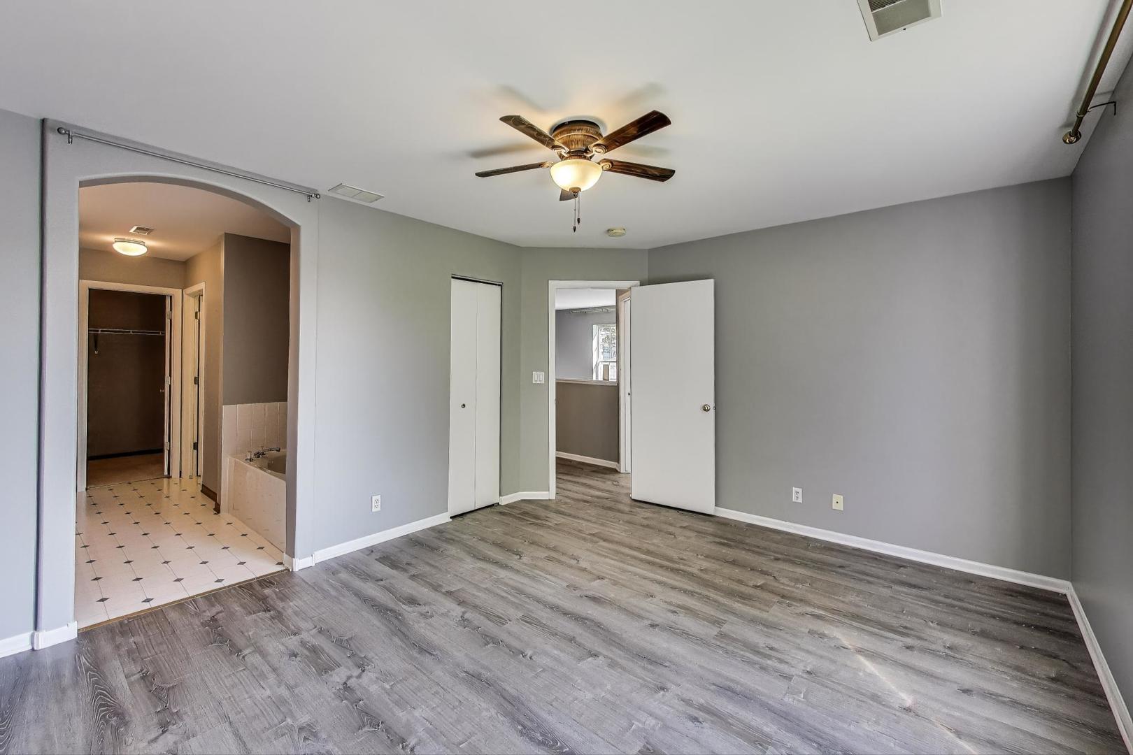383 Cascade Lane Oswego, IL 60543 - Photo 19 of 35 a view of a livingroom with a ceiling fan & wooden floor