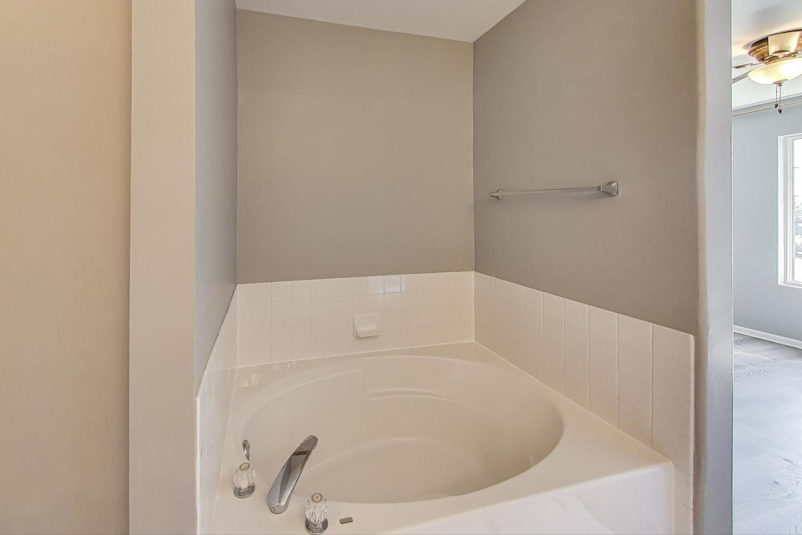 383 Cascade Lane Oswego, IL 60543 - Photo 22 of 35 a white bath tub sitting in a bathroom