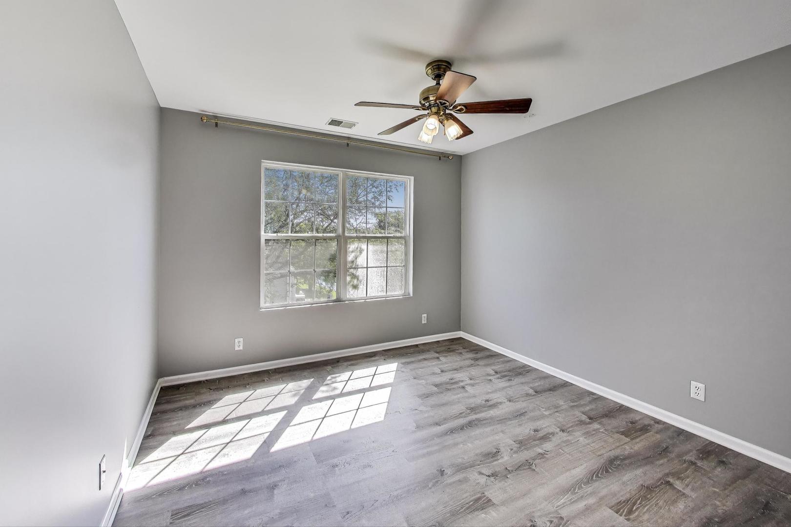 383 Cascade Lane Oswego, IL 60543 - Photo 24 of 35 an empty room with wooden floor fan and windows