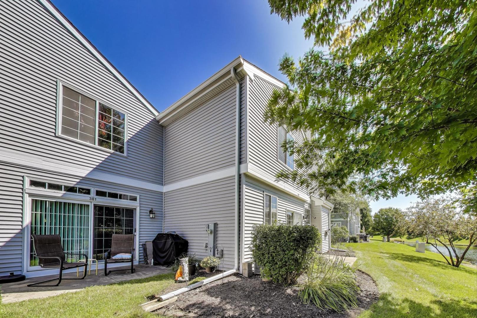 383 Cascade Lane Oswego, IL 60543 - Photo 29 of 35 a view of a house with backyard and a tree