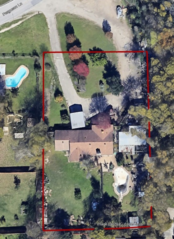 Aerial view of property and surrounding area with property boundaries highlighted and a pool area