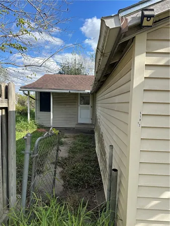 a yellow house with trees in front of it