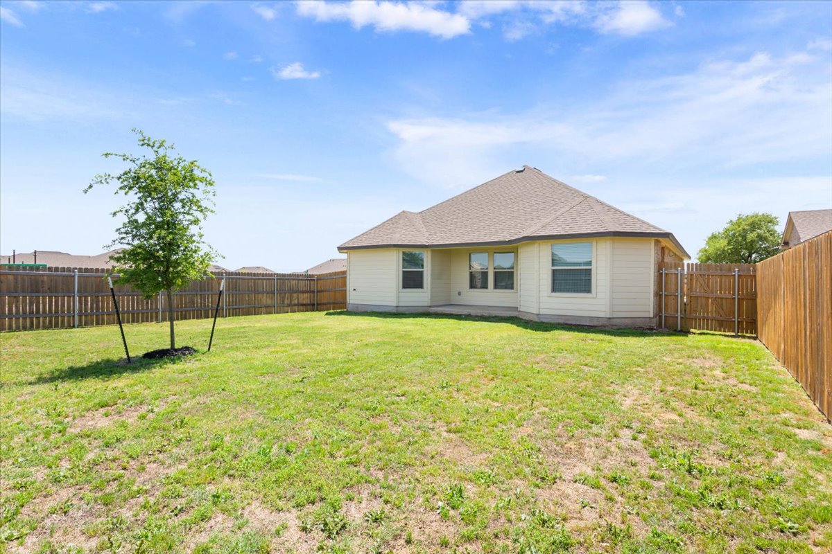 5830 Copano Road Belton, TX 76513 - Photo 32 of 34 Back of house featuring a fenced backyard and a lawn
