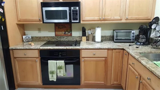 a bedroom with granite countertop stainless steel appliances a chimney and a counter space