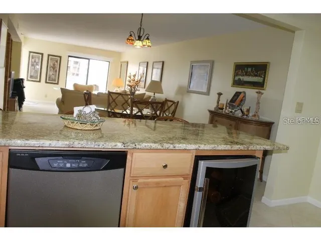 a living room with furniture and kitchen view
