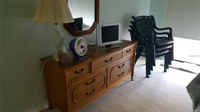 a bed with a white comforter and pillows