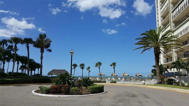 a view of a houses with palm trees
