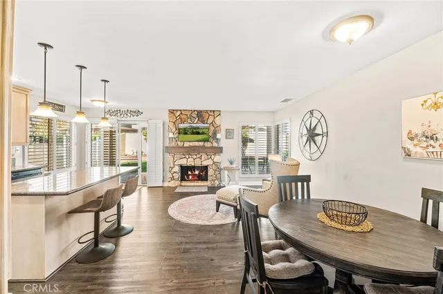 a living room with furniture a fireplace and a floor to ceiling window