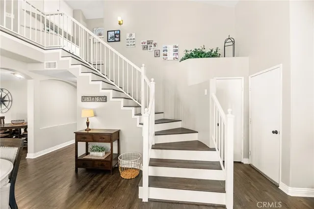 a view of a dining room with furniture and a chandelier