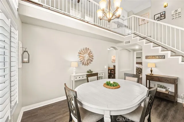 a living room with furniture a flat screen tv and floor to ceiling window