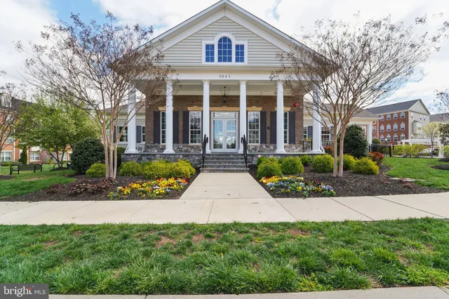 a front view of a house with yard and green space