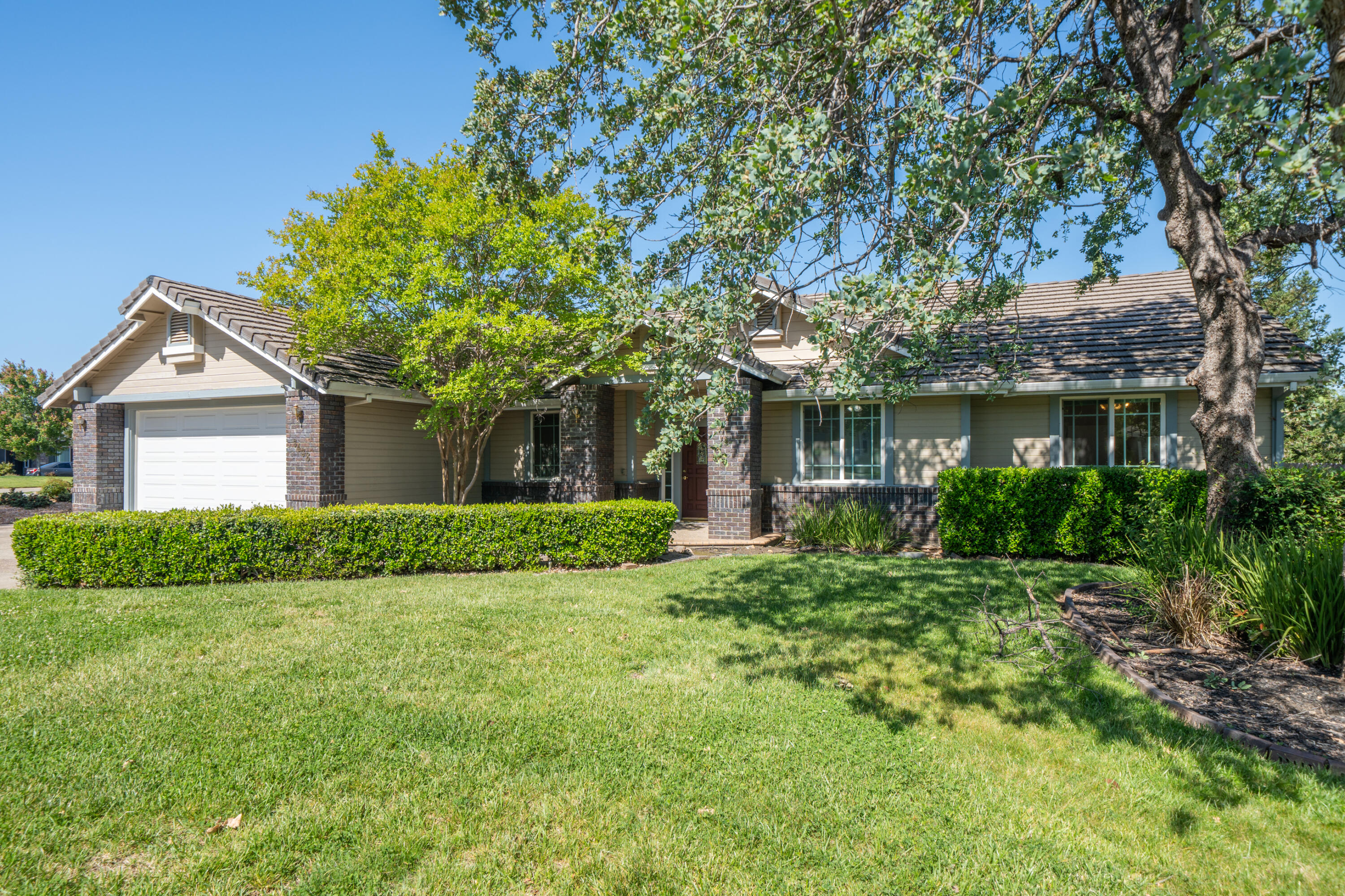 a front view of a house with a yard and garage