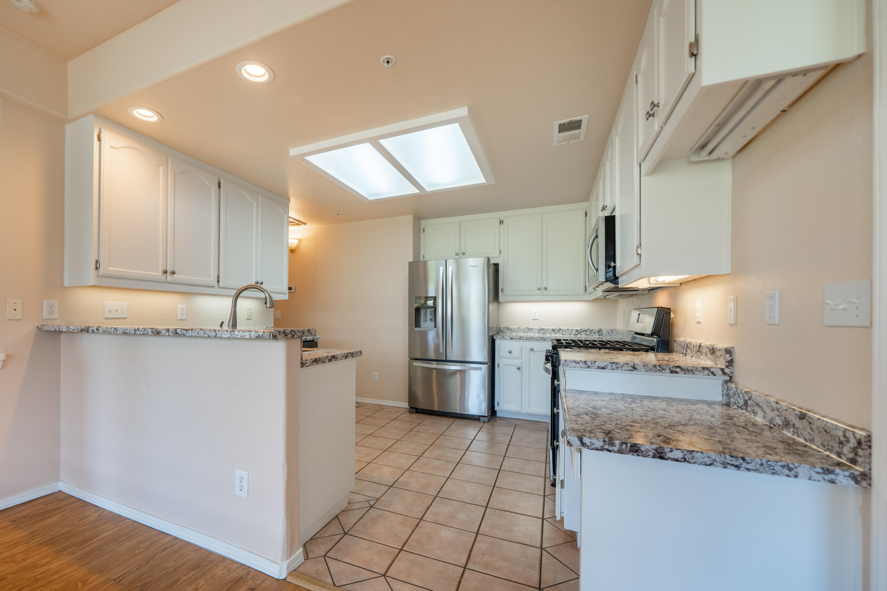 3438 Showboat Court Redding, CA 96003 - Photo 17 of 63 a kitchen with a sink cabinets and stainless steel appliances