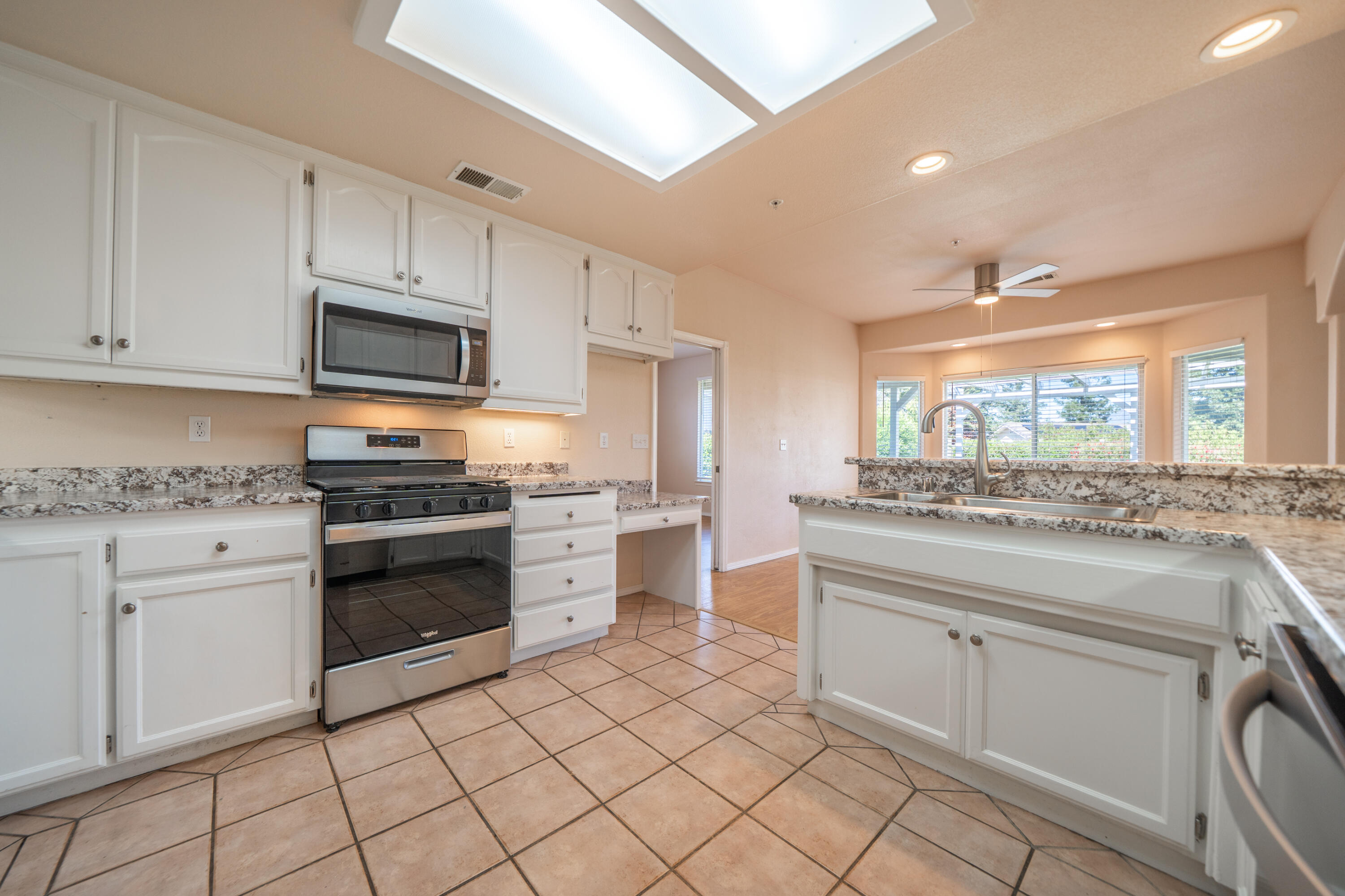 3438 Showboat Court Redding, CA 96003 - Photo 19 of 63 a kitchen with granite countertop cabinets and steel stainless steel appliances