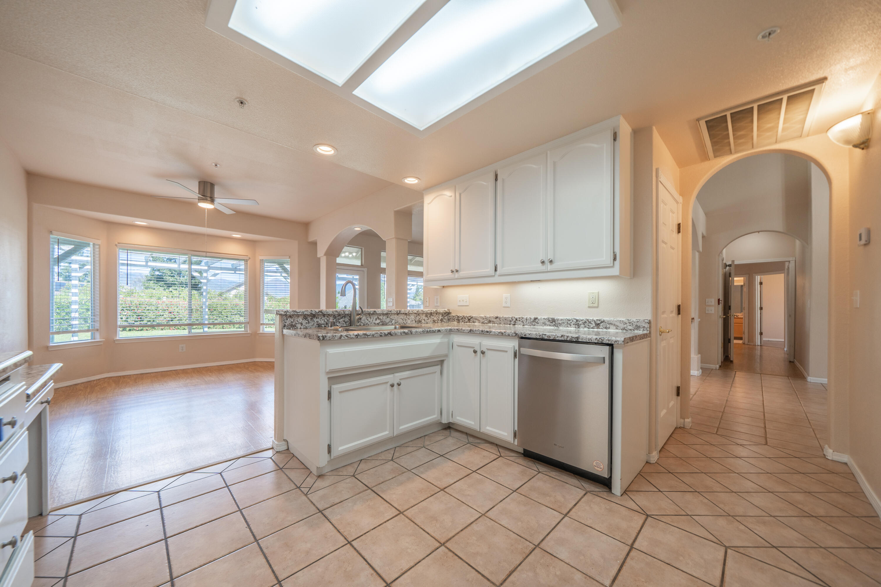 3438 Showboat Court Redding, CA 96003 - Photo 20 of 63 a kitchen with granite countertop cabinets and window