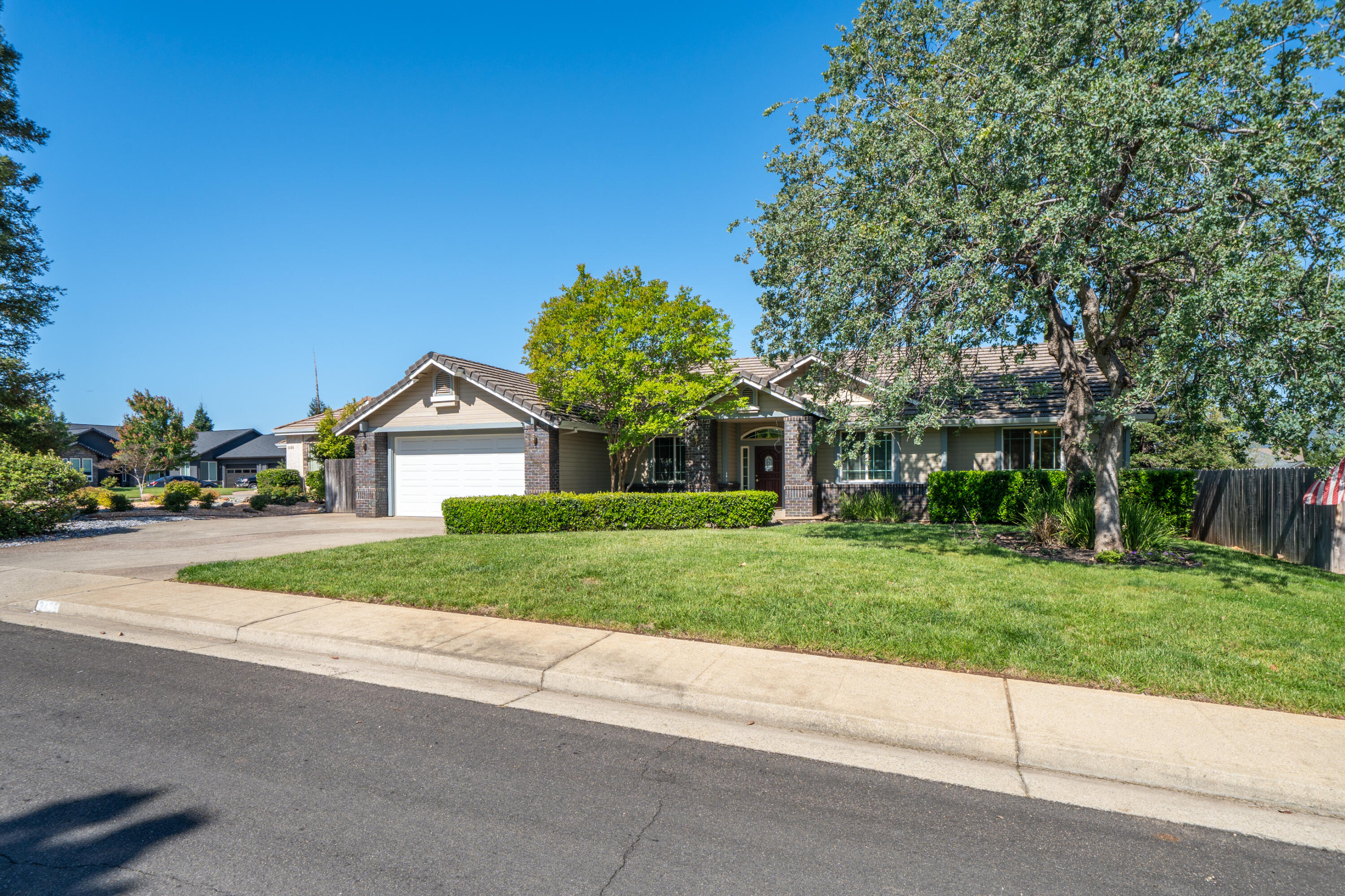 3438 Showboat Court Redding, CA 96003 - Photo 2 of 63 a front view of a house with a yard and garage