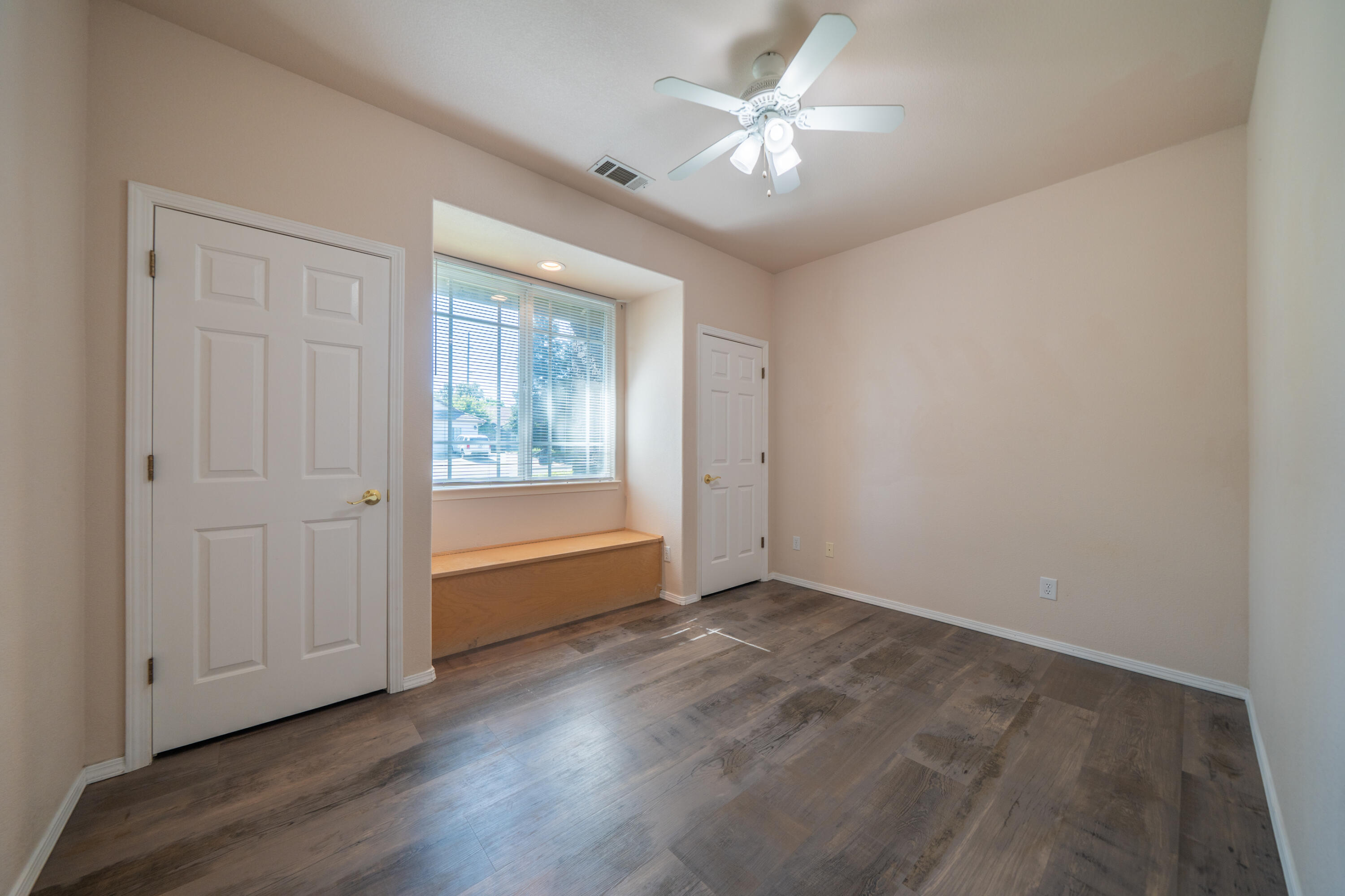 3438 Showboat Court Redding, CA 96003 - Photo 24 of 63 an empty room with wooden floor chandelier fan and windows