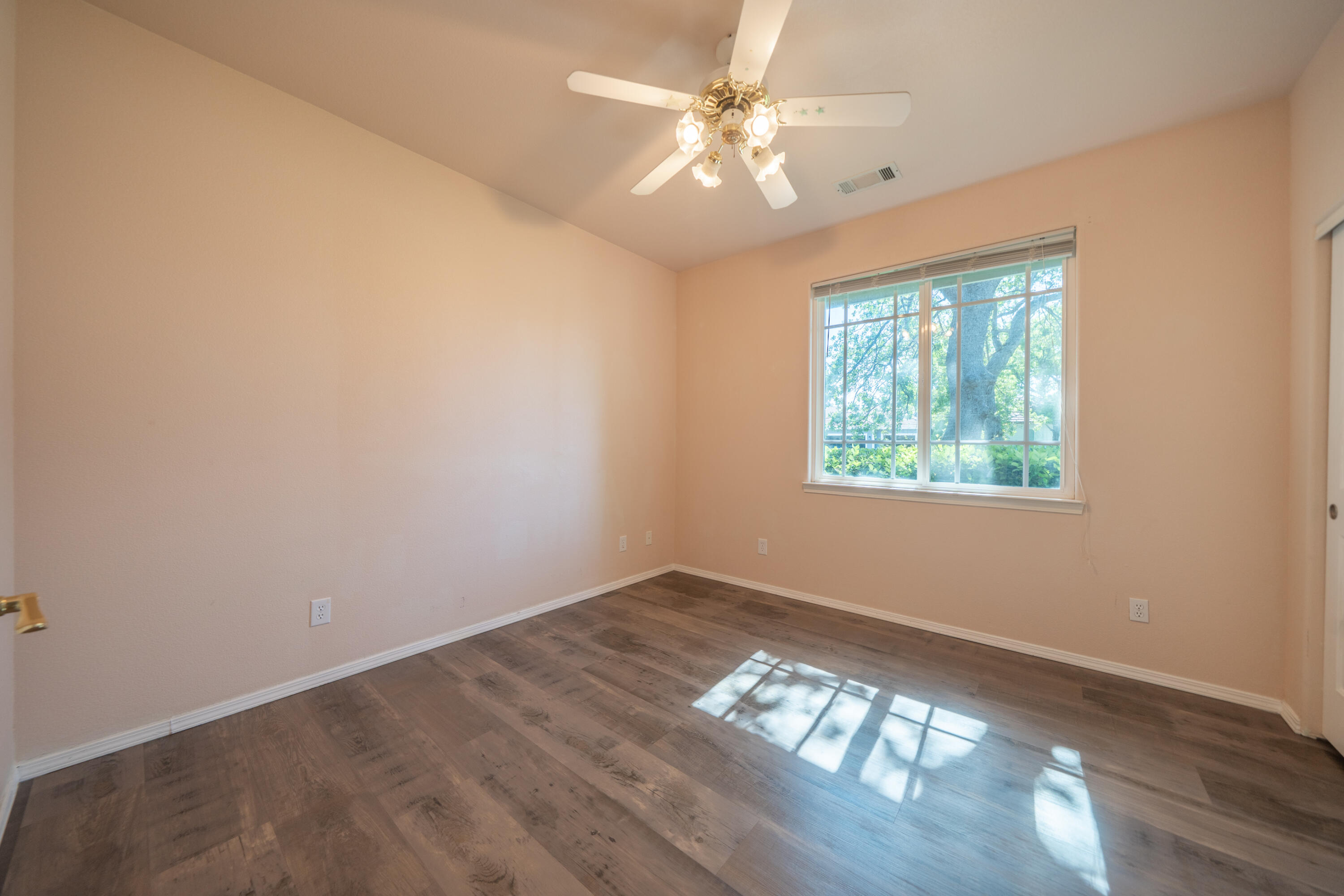 3438 Showboat Court Redding, CA 96003 - Photo 26 of 63 an empty room with wooden floor and windows