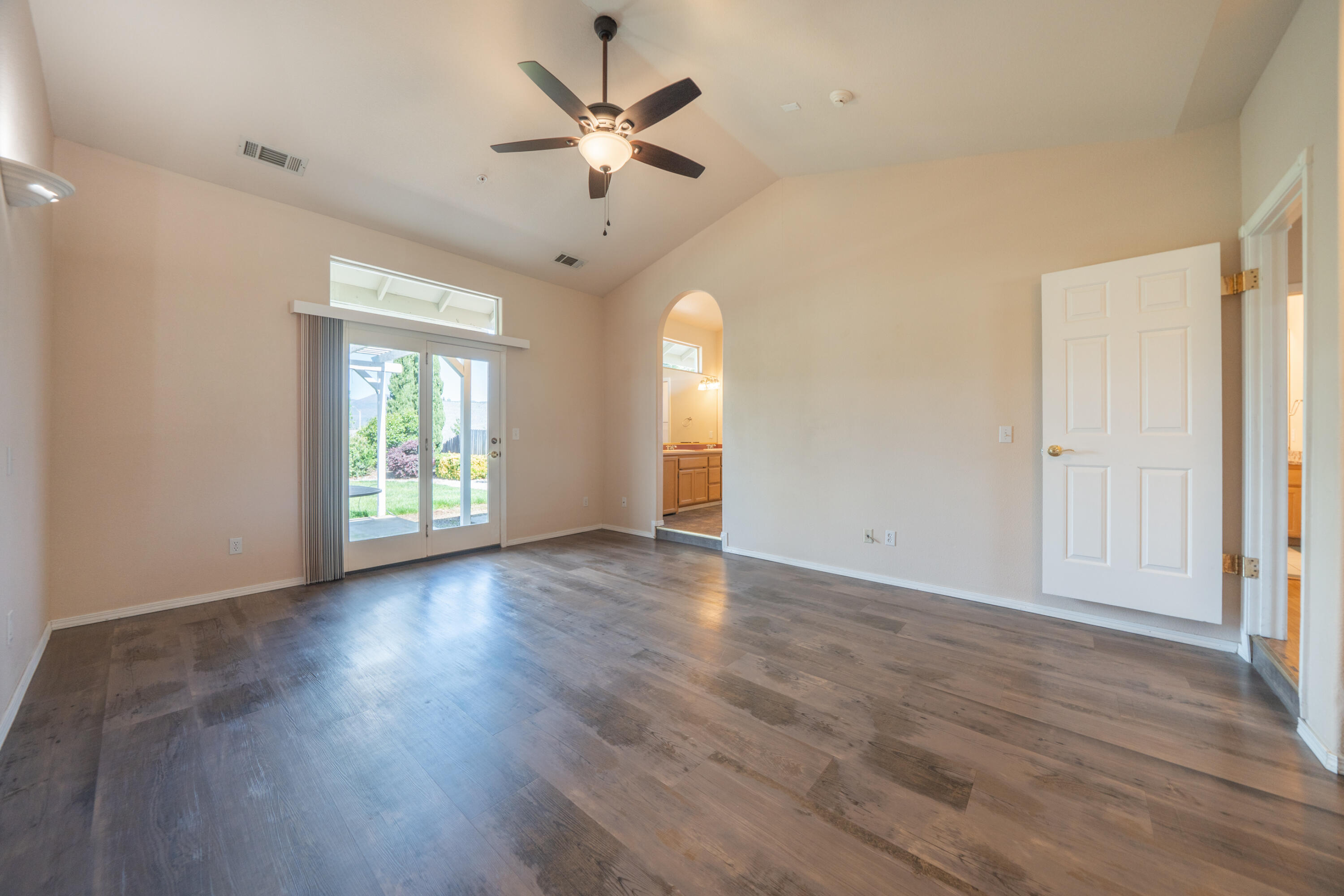 3438 Showboat Court Redding, CA 96003 - Photo 31 of 63 an empty room with wooden floor chandelier fan and windows
