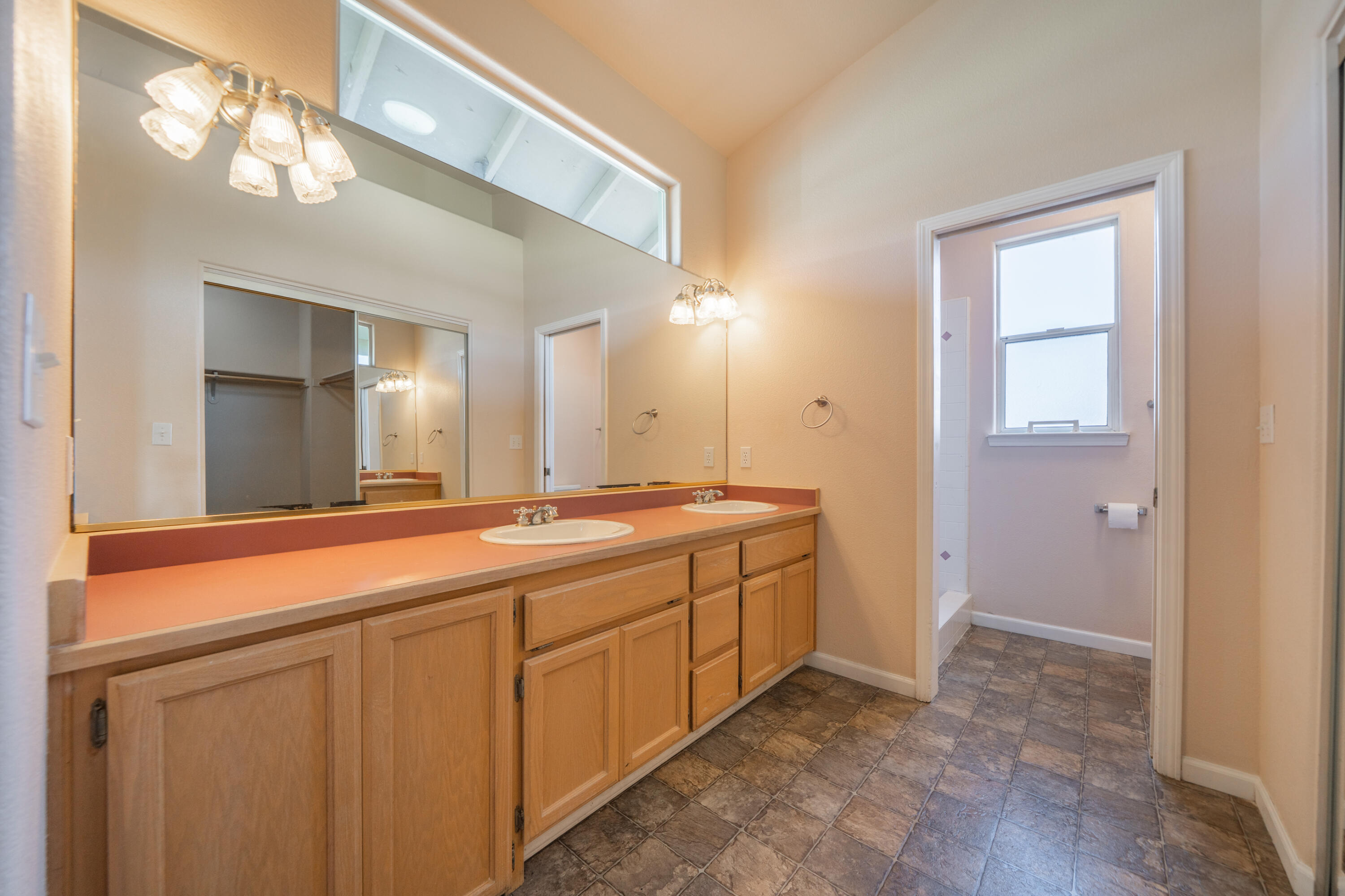 3438 Showboat Court Redding, CA 96003 - Photo 33 of 63 a spacious bathroom with a double vanity sink and a mirror