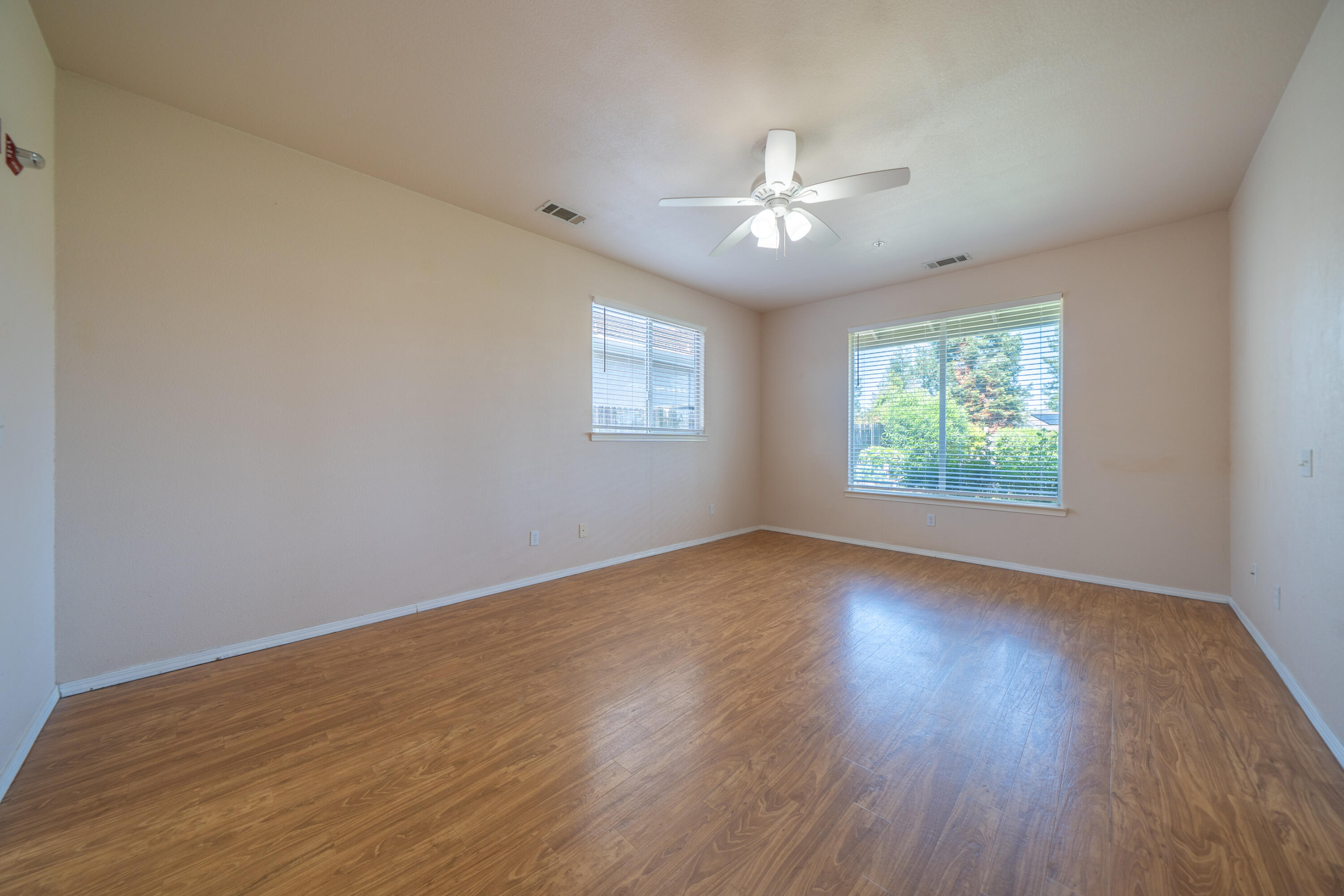 3438 Showboat Court Redding, CA 96003 - Photo 36 of 63 a view of an empty room with wooden floor and a window