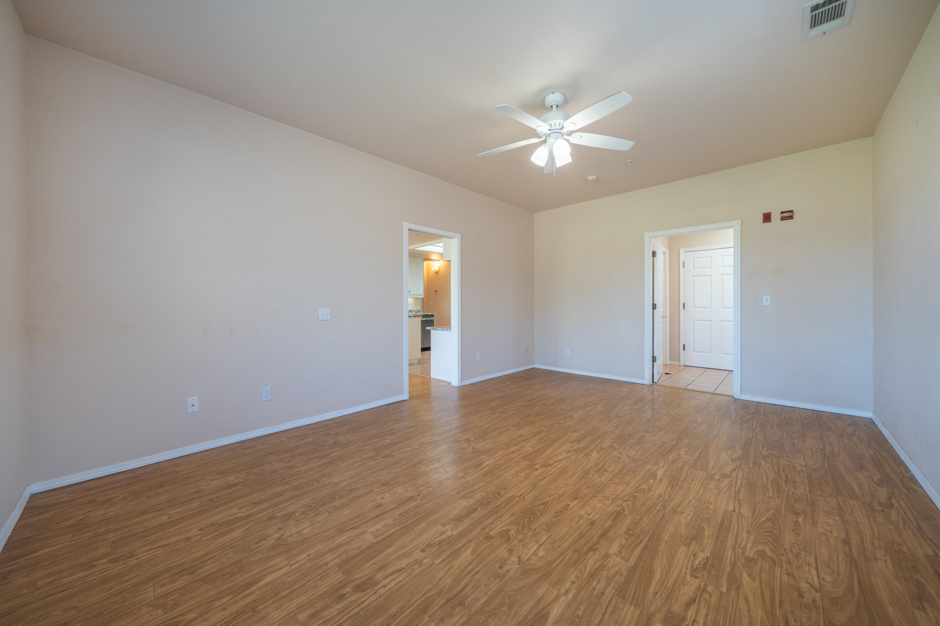 3438 Showboat Court Redding, CA 96003 - Photo 37 of 63 a view of an empty room with wooden floor and a ceiling fan